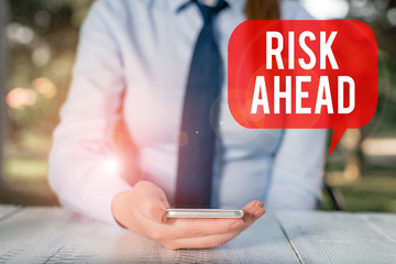 Writing note showing Risk Ahead. Business concept for A probability or threat of damage, injury,...