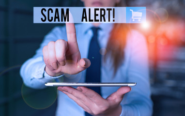 Handwriting text writing Scam Alert. Conceptual photo fraudulently obtain money from victim by persuading him Blurred woman in the background pointing with finger in empty space