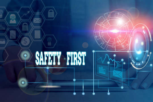 Writing note showing Safety First. Business concept for used to say that the most important thing is to be safe Picture photo network scheme with modern smart device