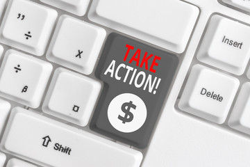 Writing note showing Take Action. Business concept for do something official or concerted to achieve aim with problem White pc keyboard with note paper above the white background
