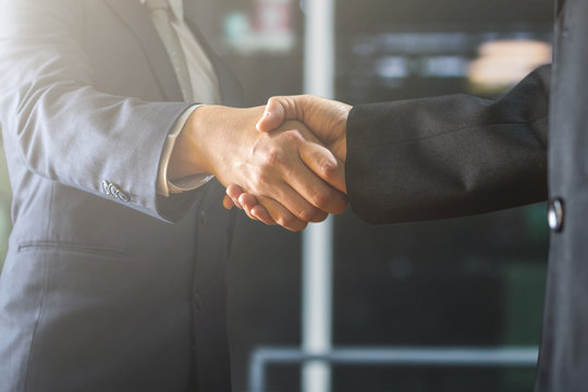 successful negotiate and handshake concept, two businessman shake hand with parthner to celebration partnership and teamwork, business deal
