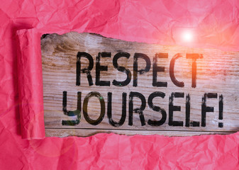 Conceptual hand writing showing Respect Yourself. Concept meaning believing that you good and worthy being treated well Cardboard which is torn placed above a wooden classic table