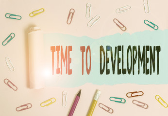 Handwriting text writing Time To Development. Conceptual photo a length of time during which a company grows or develop Stationary and torn cardboard placed above a plain pastel table backdrop
