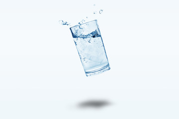 Water splashes in a glass of water floating, copy space 