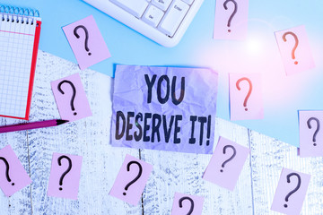 Text sign showing You Deserve It. Business photo showcasing should have it because of their qualities or actions Writing tools, computer stuff and math book sheet on top of wooden table