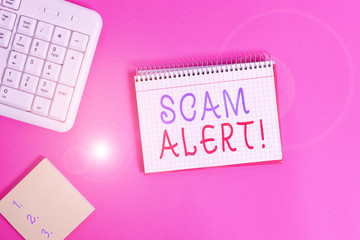 Text sign showing Scam Alert. Business photo showcasing fraudulently obtain money from victim by persuading him Writing equipments and computer stuffs placed above classic wooden table