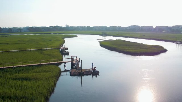 Drone of a Man fishing with his dog