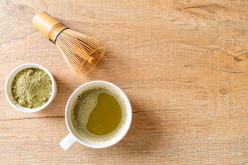 hot matcha green tea cup with green tea powder and whisk