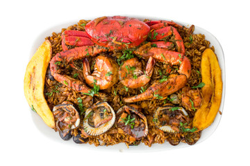 Top view of seafood with rice isolated in a white backgorund. Delicious ecuadorian dish with crab, shrimps, mussels, fried banana and rice. Studio shot seaman rice.