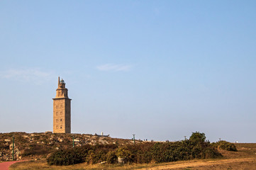 Fototapeta na wymiar Ancient Roman lighthouse Tower of Hercules (Torre de Hércules) with bright sky