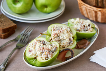Raw apples stuffed with herring and eggs 