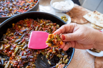 Old woman enjoying some homemade okra
