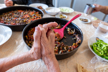 Old woman enjoying some homemade okra