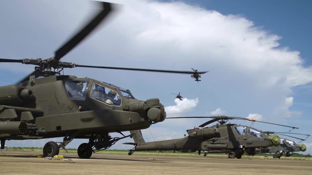 Military Apache helicopters taking off