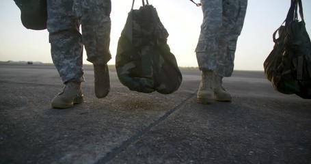 Slow Motion Military boots walking at sunrise
