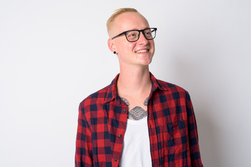 Face of happy young blonde hipster man thinking and looking up