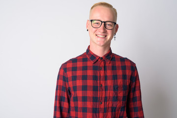 Face of happy young blonde hipster man smiling at camera