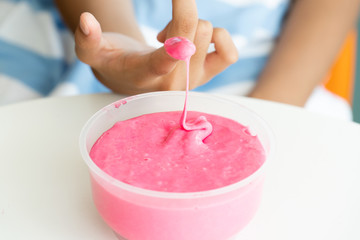 Hand Holding Homemade Toy Called Slime, Kids having fun and being creative by science experiment
