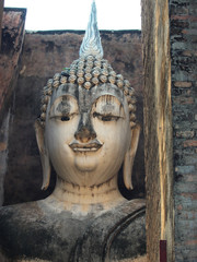 Buddha statue and archaeological site at wat Si Chum templ, popular tourist attractions and famous landmarks in Sukhothai historical park, Sukhothai, Thailand. UNESCO world heritage city.