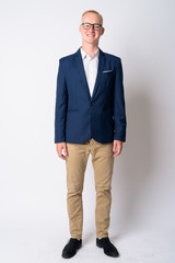 Full body shot of happy young blonde businessman in suit smiling