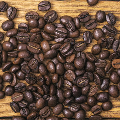 Coffee bean. The background of roasted coffee beans is brown on wooden boards. layout. Flat lay.