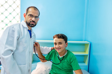 Doctor checking on his patient with his stethoscope