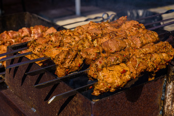 Skewers with meat over the charcoals. Cooking shashlik