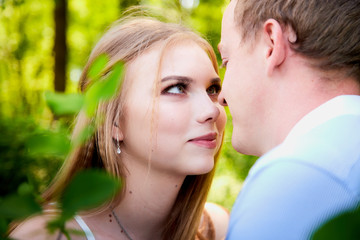 Young man and woman couple walk in the park. Spring or summer love story. Young happy family