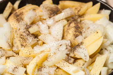 Striped flavored potato flavored with pepper and salt in a pan.