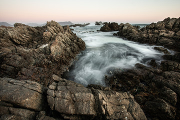 Motion blur waves over the rocks on the coast