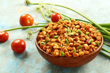 Homemade vegan diet foods- roasted chickpeas with spices and herbs