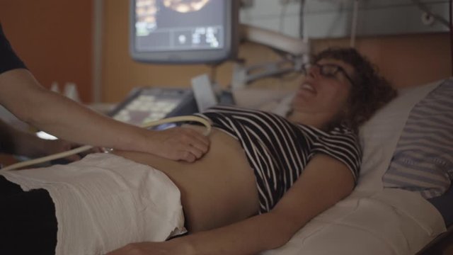 Mother Lying Down on a Hospital Bed for an Ultrasound