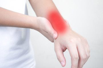 Close-up of Asian hand pain and wrist pain and suffering from wrist pain from work.Isolated background.