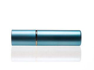 Blue color cosmetic spray bottle horizontally on white background with reflection