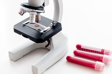 Blood testing. Samples viewing under microscope on white background top view copy space