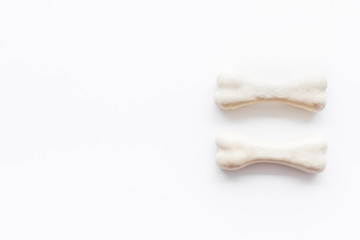 Treats for dogs. Chewing bones on white background top view space for text