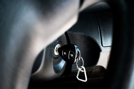The car key in the keyhole to start the car. Close up.