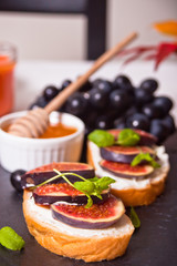 Sandwich with cream cheese, figs and honey. Healthy food concept