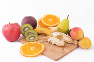 Fresh fruits on the white background beautiful on a wooden board. white background