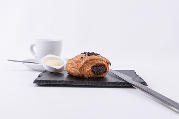 Fresh butter and a roll of chocolate-filled puff pastry