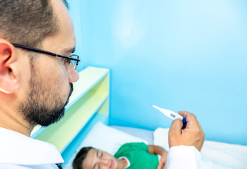 Doctor checking for his patient high temperature