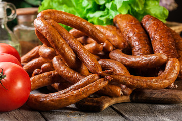 Assorted smoked sausages on a cutting board