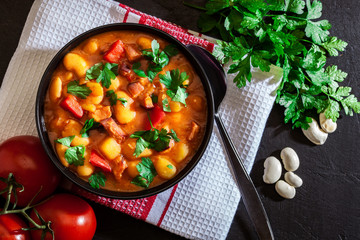 White bean soup with potatoes, tomatoes, paprika, and bacon