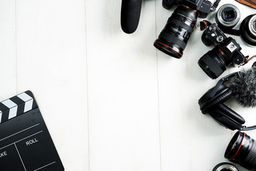Camping or adventure trip scenery concept. Backpack, boots, belt, thermos and camera on wooden...