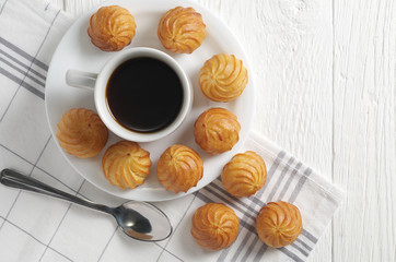Small custard cakes and coffee