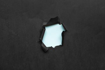 black Hole in the paper with torn sides.