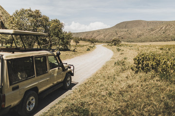 Safari in Hell's Gate national park in Kenya. Off road jeep car, savanna and mountain view. Explore wilderness of Africa.