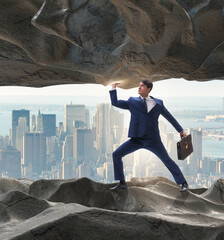 Businessman supporting stone under pressure