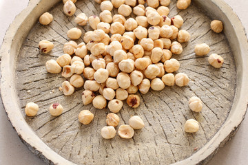 Hazelnuts on rough wooden background.