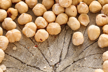 Hazelnuts on rough wooden background.